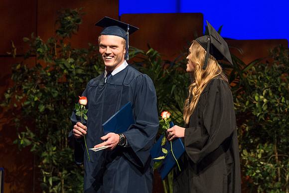 Students of the College of Agriculture and Life Sciences walk across the stage and receive their diplomas.