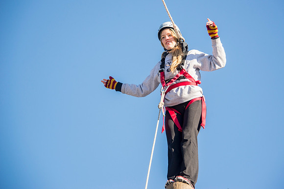 Student Haley Beautler climbs up the Power Pole at iGrow.