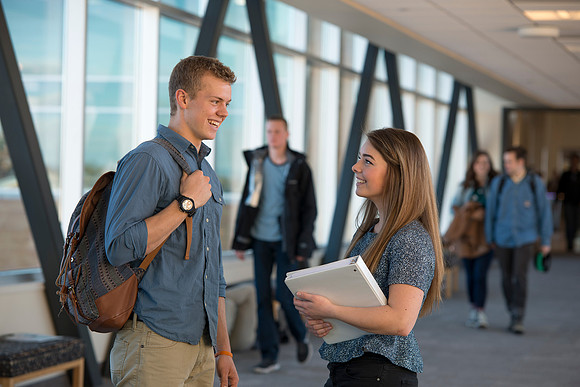 BYU-Idaho students, Collin and Martina in the Skywalk between the Manwaring Center and the McKay Library.
