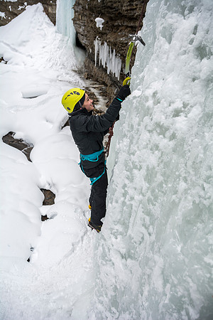 Ashlyn Cuneo, a local from Idaho Falls, climbs with students on an Outdoor Activities ice climbing trip.