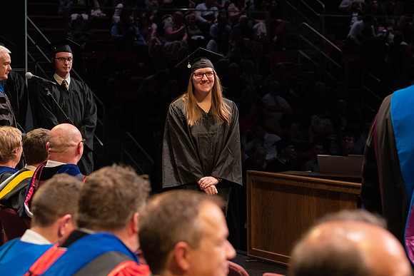 Students graduate and walk to receive their diplomas during convocation in the College of Physical Sciences and Engineering.