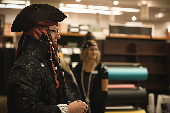 Employees of the University Store on campus stop for a photo in their Halloween costumes.