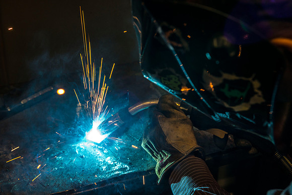 Clay Rasmussen, from the Mechanical Engineering Department, welds during a demonstration.