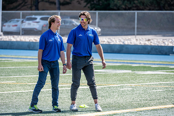Coaches teach younger kids ages 12-16 exercise drills on the BYU-Idaho stadium field at a speed and agility camp.
