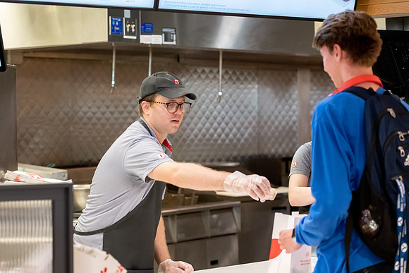 Employees of the Chick-Fil-A on the BYU-Idaho campus working and helping students.