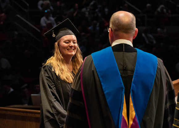 Students graduate and walk to receive their diplomas during convocation in the College of Physical Sciences and Engineering.