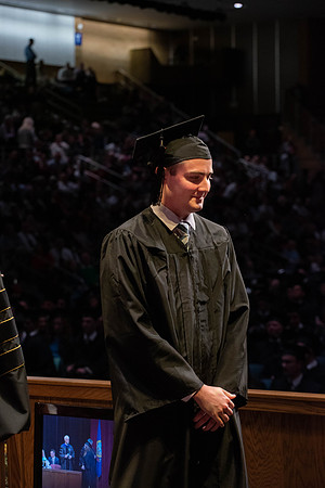 Students graduate and walk to receive their diplomas during convocation in the College of Physical Sciences and Engineering.