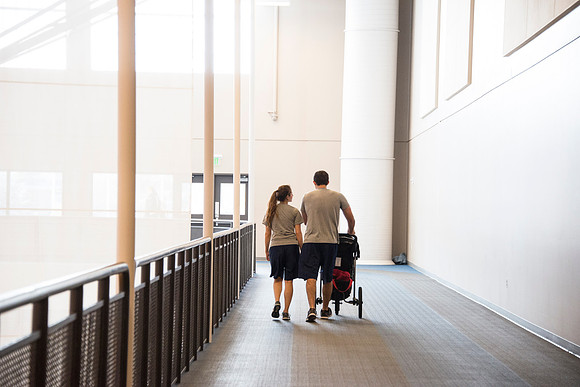 A young family takes advantage of the indoor track while it snows outside.