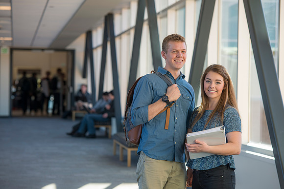 BYU-Idaho students, Collin and Martina in the Skywalk between the Manwaring Center and the McKay Library.