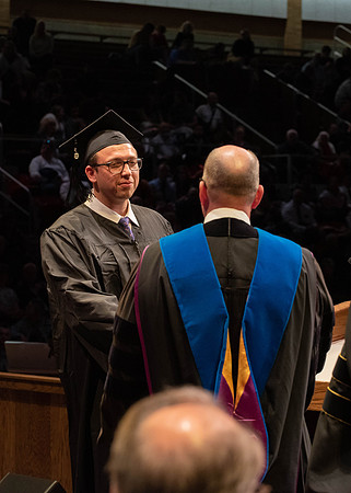 Students graduate and walk to receive their diplomas during convocation in the College of Physical Sciences and Engineering.