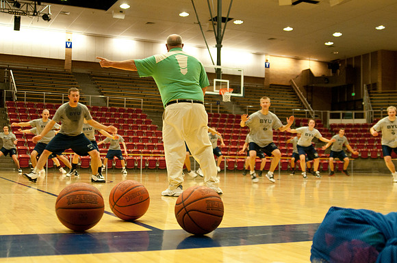 Basketball class students and choach doing basketball drills