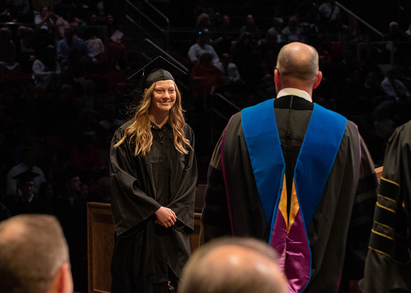 Students graduate and walk to receive their diplomas during convocation in the College of Physical Sciences and Engineering.