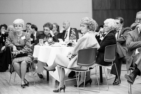 Members of the audience listen to the quartet sing a number