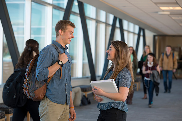 BYU-Idaho students, Collin and Martina in the Skywalk between the Manwaring Center and the McKay Library.
