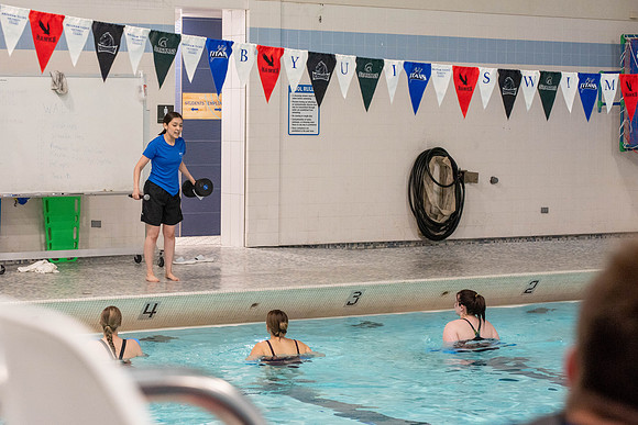 Students workout together in the pool at the Hart Building. Water Areobics Class taught by an instructor.
