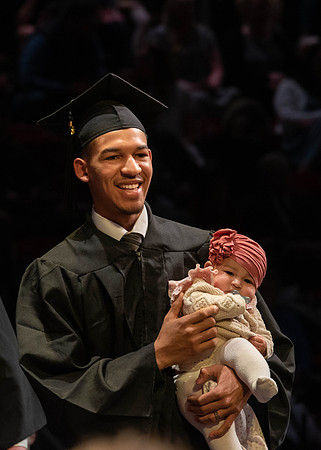 Students graduate and walk to receive their diplomas during convocation in the College of Physical Sciences and Engineering.