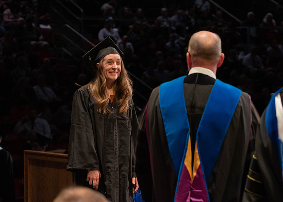 Students graduate and walk to receive their diplomas during convocation in the College of Physical Sciences and Engineering.
