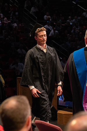 Students graduate and walk to receive their diplomas during convocation in the College of Physical Sciences and Engineering.