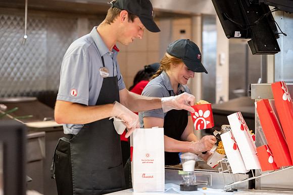 Employees of the Chick-Fil-A on the BYU-Idaho campus working and helping students.