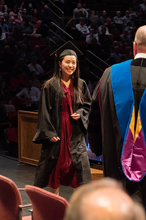 Students graduate and walk to receive their diplomas during convocation in the College of Physical Sciences and Engineering.