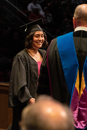 Students graduate and walk to receive their diplomas during convocation in the College of Physical Sciences and Engineering.