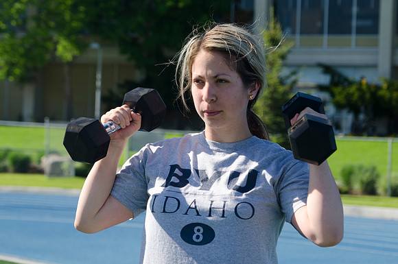 A cross-weight training class takes advantage of some beautiful weather to train in the Hart Stadium.