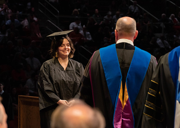 Students graduate and walk to receive their diplomas during convocation in the College of Physical Sciences and Engineering.