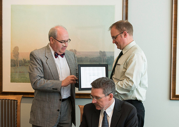 University Relations department luncheon in the Presidents Dining Room in the Manwaring Center. Merv Brown presents Jeff Dunster with his service award.