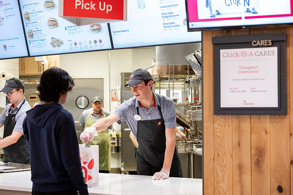 Employees of the Chick-Fil-A on the BYU-Idaho campus working and helping students.
