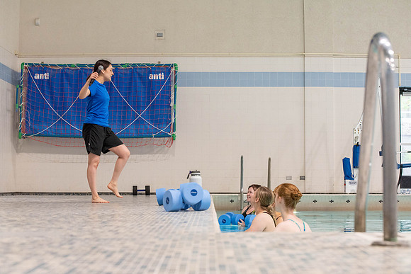 Students workout together in the pool at the Hart Building. Water Areobics Class taught by an instructor.