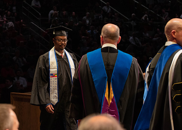 Students graduate and walk to receive their diplomas during convocation in the College of Physical Sciences and Engineering.