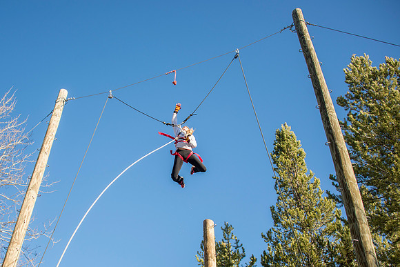 Student Haley Beautler climbs up the Power Pole at iGrow.