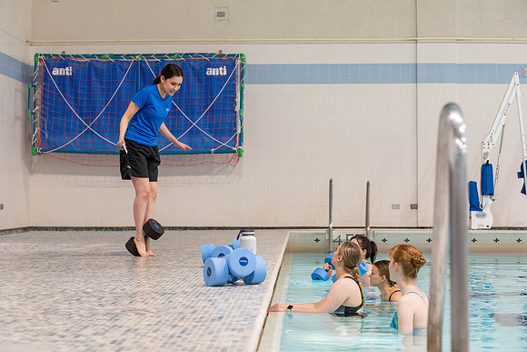 Students workout together in the pool at the Hart Building. Water Areobics Class taught by an instructor.