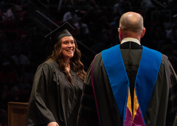 Students graduate and walk to receive their diplomas during convocation in the College of Physical Sciences and Engineering.