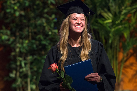 Students of the College of Agriculture and Life Sciences walk across the stage and receive their diplomas.
