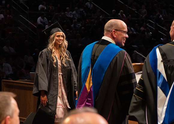 Students graduate and walk to receive their diplomas during convocation in the College of Physical Sciences and Engineering.