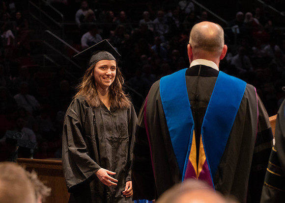 Students graduate and walk to receive their diplomas during convocation in the College of Physical Sciences and Engineering.