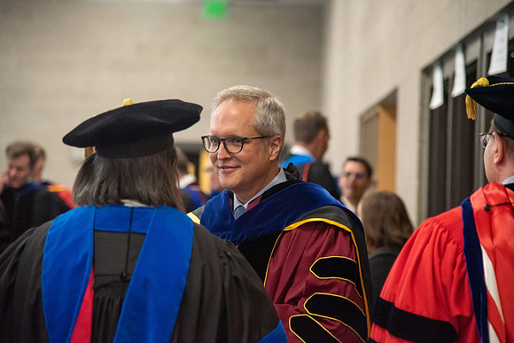 Student Graduates and Faculty meet in the I-Center for Commencement.