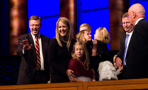 Clark G. Gilbert and his family recognize a familiar face in the crowd. Taken by Erik Hill.