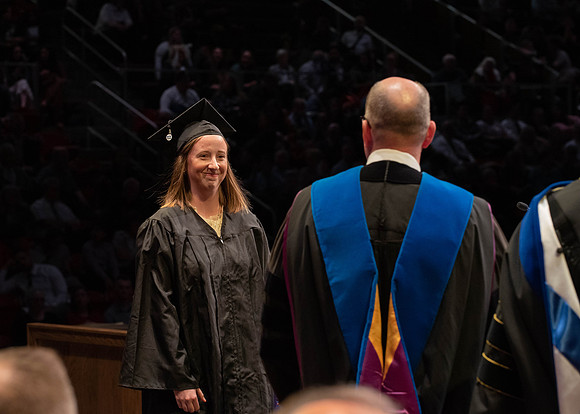 Students graduate and walk to receive their diplomas during convocation in the College of Physical Sciences and Engineering.