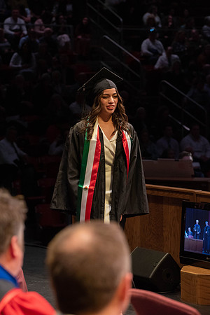 Students graduate and walk to receive their diplomas during convocation in the College of Physical Sciences and Engineering.