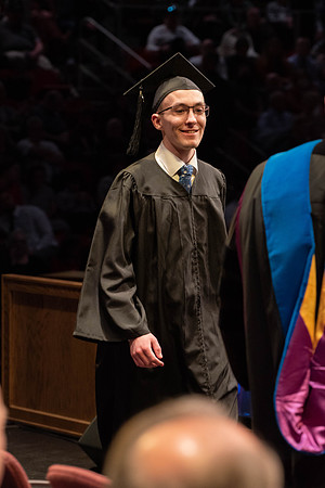 Students graduate and walk to receive their diplomas during convocation in the College of Physical Sciences and Engineering.
