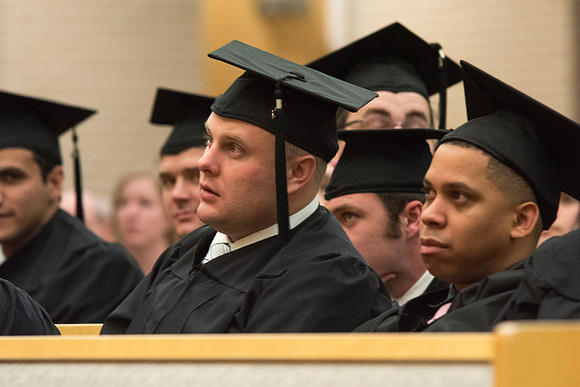 Graduates listening to their fellow Classmate give a speech