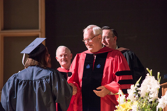 Elder Robert C. Gay of the First Quorum of the Seventy along President Kim B. Clark and John Linford, Dean of the College of Foundations and Interdisciplinary Studies present the graduates with thier