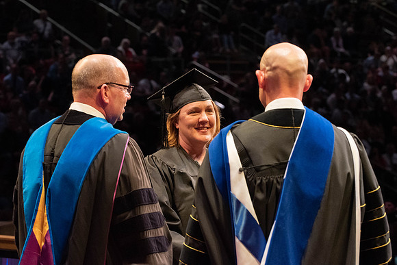 Students graduate and walk to receive their diplomas during convocation in the College of Physical Sciences and Engineering.