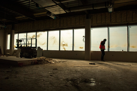 A construction worker talks on the phone while the new Science Technology building is under construction.