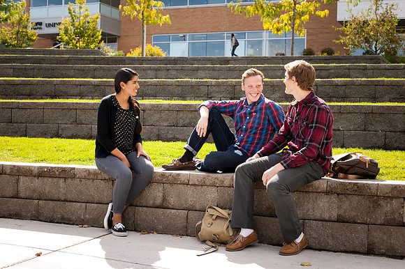 Wendy Pineda, Cameron VanKammen, and Stephen Beyer enjoy the beautiful fall weather in the quad.