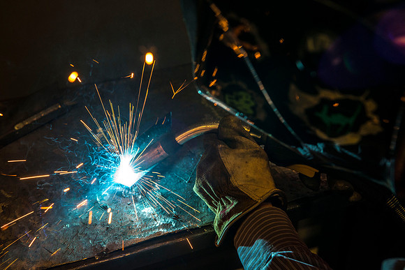 Clay Rasmussen, from the Mechanical Engineering Department, welds during a demonstration.