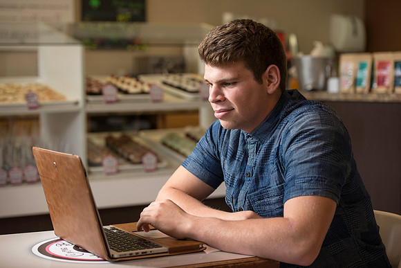 Blake Jensen studies for an Online class at the Cocoa Bean Cafe in Rexburg, ID.