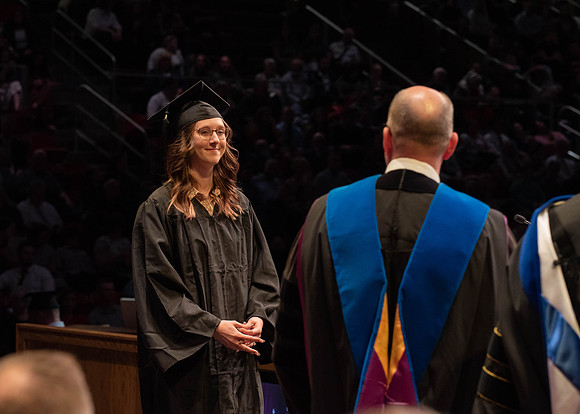 Students graduate and walk to receive their diplomas during convocation in the College of Physical Sciences and Engineering.